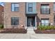 Close up of an inviting townhome entrance with a well-manicured garden, stone steps, and a stylish door at 1842 Central Ave, Indianapolis, IN 46202