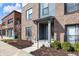 Cozy townhouse entryway with a covered porch, neatly trimmed shrubs, and a welcoming front door at 1842 Central Ave, Indianapolis, IN 46202