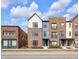Attractive exterior view of brick townhomes with blue siding accents and well-maintained landscaping on a sunny day at 1842 Central Ave, Indianapolis, IN 46202