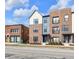 Charming street view of new brick townhouses featuring colorful accents, neat landscaping, and a vibrant neighborhood feel at 1842 Central Ave, Indianapolis, IN 46202