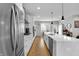 Modern kitchen with a waterfall island, stainless steel appliances, ample counter space, and hardwood floors at 1842 Central Ave, Indianapolis, IN 46202