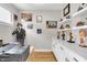 Well-lit office space featuring built-in shelving, a desk, and hardwood floors at 1842 Central Ave, Indianapolis, IN 46202
