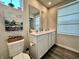Bathroom features double vanity sinks, wood-look flooring, and contemporary fixtures at 1862 Cascades Dr, Greenfield, IN 46140