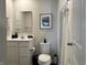 Well-lit bathroom featuring a vanity with sink, toilet, and shower with a white curtain at 1862 Cascades Dr, Greenfield, IN 46140