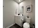Bright half-bathroom featuring a vanity with sink, toilet, and decorative wall art at 1862 Cascades Dr, Greenfield, IN 46140