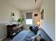 Comfortable home office features natural light, cozy seating, and rustic wood furniture at 1862 Cascades Dr, Greenfield, IN 46140