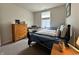 Cozy bedroom with natural light, featuring a keyboard, dresser, and comfortable bed at 1862 Cascades Dr, Greenfield, IN 46140