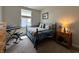 Comfortable bedroom with natural light, featuring a keyboard, dresser, and nightstand with a sailboat at 1862 Cascades Dr, Greenfield, IN 46140