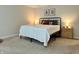 Comfortable bedroom featuring neutral décor, a metal-framed bed and coordinating lamps at 1862 Cascades Dr, Greenfield, IN 46140