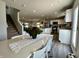 A view of the dining room next to the living room and kitchen with hardwood floors at 1862 Cascades Dr, Greenfield, IN 46140