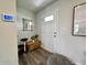 Bright and inviting entryway featuring modern decor, stylish mirror, and wood-look flooring at 1862 Cascades Dr, Greenfield, IN 46140