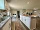 Bright, modern kitchen features granite countertops, stainless steel appliances, and a large island at 1862 Cascades Dr, Greenfield, IN 46140