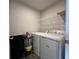 Functional laundry room equipped with modern washer and dryer appliances, and shelving at 1862 Cascades Dr, Greenfield, IN 46140