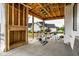 Covered patio construction showing framing and concrete flooring overlooking neighboring houses at 19909 Windsor Park Blvd, Westfield, IN 46069