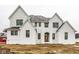 Stunning new construction home with white painted brick and vertical siding and contrasting black window frames at 19909 Windsor Park Blvd, Westfield, IN 46069