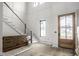 Bright foyer with decorative trim, staircase, and natural wood front door provides a grand entrance at 19909 Windsor Park Blvd, Westfield, IN 46069