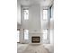 Sun-filled living room showcasing a fireplace, large windows and high ceilings creating an airy atmosphere at 19909 Windsor Park Blvd, Westfield, IN 46069