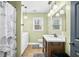 Bathroom featuring a modern vanity, a toilet, and a washer and dryer adjacent to a window with blinds at 2072 S Rembrandt Cv, Martinsville, IN 46151