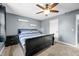 Cozy bedroom featuring a dark wood sleigh bed, gray walls, and a ceiling fan for comfort at 2072 S Rembrandt Cv, Martinsville, IN 46151