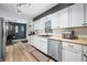 View of kitchen with stainless steel appliances and countertops, dark accent wall, and open space at 2072 S Rembrandt Cv, Martinsville, IN 46151