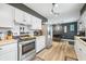 View of kitchen with stainless steel appliances, modern decor, white cabinets, and stainless appliances at 2072 S Rembrandt Cv, Martinsville, IN 46151