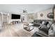 Spacious living room with hardwood floors and a large TV, perfect for entertaining at 2072 S Rembrandt Cv, Martinsville, IN 46151