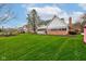 Beautiful backyard featuring an expansive lawn, mature trees, and a charming home exterior at 222 Wellington Pkwy, Noblesville, IN 46060