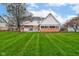Spacious backyard featuring a well-manicured lawn, brick accents, and a home exterior at 222 Wellington Pkwy, Noblesville, IN 46060