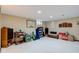 A large, carpeted basement area with seating, storage, and plenty of open space, great for customization at 222 Wellington Pkwy, Noblesville, IN 46060