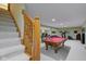 Finished basement with carpeted stairs and a well-lit rec area, showcasing a pool table and exercise equipment at 222 Wellington Pkwy, Noblesville, IN 46060