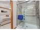 Modern bathroom featuring a zero entry shower with glass doors, grab bars, and a convenient shower seat at 222 Wellington Pkwy, Noblesville, IN 46060