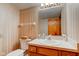 Bathroom featuring wallpaper, toilet, and vanity with a sink, with a mirror reflecting a door at 222 Wellington Pkwy, Noblesville, IN 46060