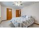 Comfortable bedroom featuring patterned bedding, ceiling fan, and wood trim accents at 222 Wellington Pkwy, Noblesville, IN 46060