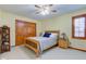 Comfortable bedroom featuring patterned bedding, ceiling fan, and wood trim accents at 222 Wellington Pkwy, Noblesville, IN 46060