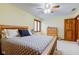 Bright bedroom with a large window, wooden trim, neutral carpet, and a ceiling fan at 222 Wellington Pkwy, Noblesville, IN 46060