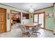 Sunny dining area with wooden table and chairs sits next to sliding glass doors at 222 Wellington Pkwy, Noblesville, IN 46060