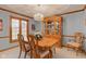 Dining room with light blue walls, hardwood trim, dining table, and crystal chandelier at 222 Wellington Pkwy, Noblesville, IN 46060