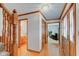 Hallway with hardwood floors, stairs, and access to a bathroom and living area at 222 Wellington Pkwy, Noblesville, IN 46060
