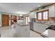 View of eat-in kitchen featuring island, sink and stainless appliances and adjoining living space at 222 Wellington Pkwy, Noblesville, IN 46060