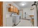 Well-equipped laundry room with a washer, dryer, folding station, and overhead cabinets at 222 Wellington Pkwy, Noblesville, IN 46060