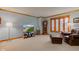Bright living room featuring hardwood trim, bay window, comfortable seating, and a grandfather clock at 222 Wellington Pkwy, Noblesville, IN 46060