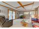 Well-lit living room with coffered ceiling and view into neighboring kitchen at 222 Wellington Pkwy, Noblesville, IN 46060