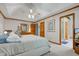 Spacious main bedroom features neutral walls, tray ceiling, ceiling fan, carpet, and an ensuite bathroom at 222 Wellington Pkwy, Noblesville, IN 46060
