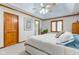 Inviting main bedroom featuring neutral walls, tray ceiling, ceiling fan, carpet, and an ensuite bathroom at 222 Wellington Pkwy, Noblesville, IN 46060