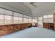 Bright sunroom boasts brick accents, large windows, and a door that leads to the outdoor spaces at 222 Wellington Pkwy, Noblesville, IN 46060