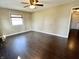 Comfortable bedroom with hardwood floors, a ceiling fan, and a doorway leading to another room at 2253 Chandler Ln, Columbus, IN 47203