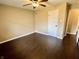 Cozy bedroom with hardwood floors, a ceiling fan, and natural light streaming through the window at 2253 Chandler Ln, Columbus, IN 47203