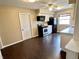 Functional kitchen with black appliances, white cabinets, and sleek hardwood flooring at 2253 Chandler Ln, Columbus, IN 47203
