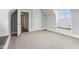 This carpeted attic space is bright and open and has wall trim and a small bench seating area at 234 S State Ave, Indianapolis, IN 46201