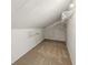 Attic storage space with carpet, white walls, and shelving for storage at 234 S State Ave, Indianapolis, IN 46201